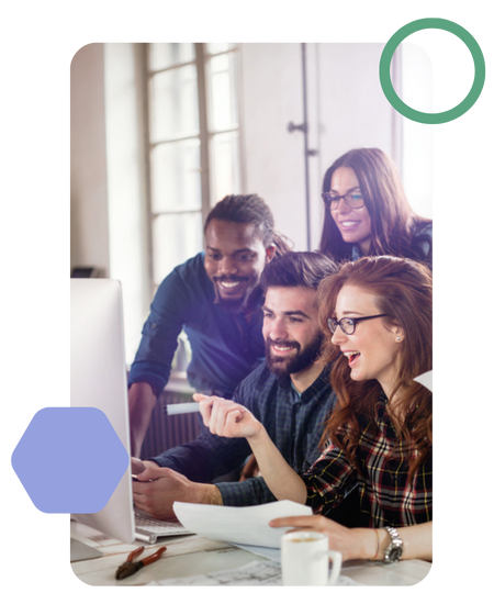 a smiling marketing team huddled around a computer screen